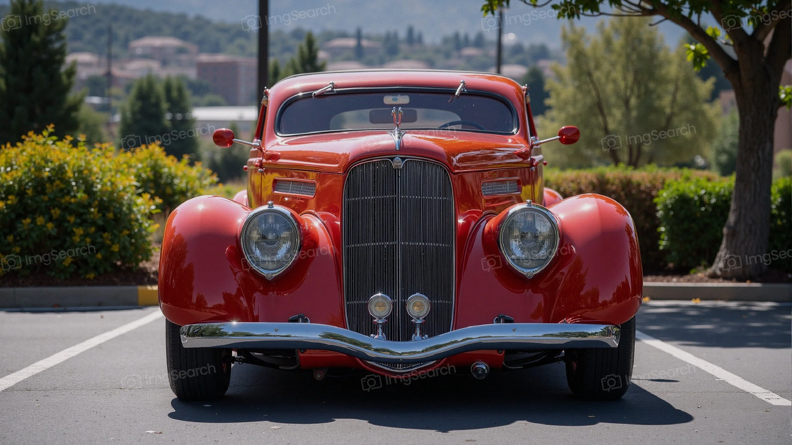 Front view of a classic red car parked in a sunny location