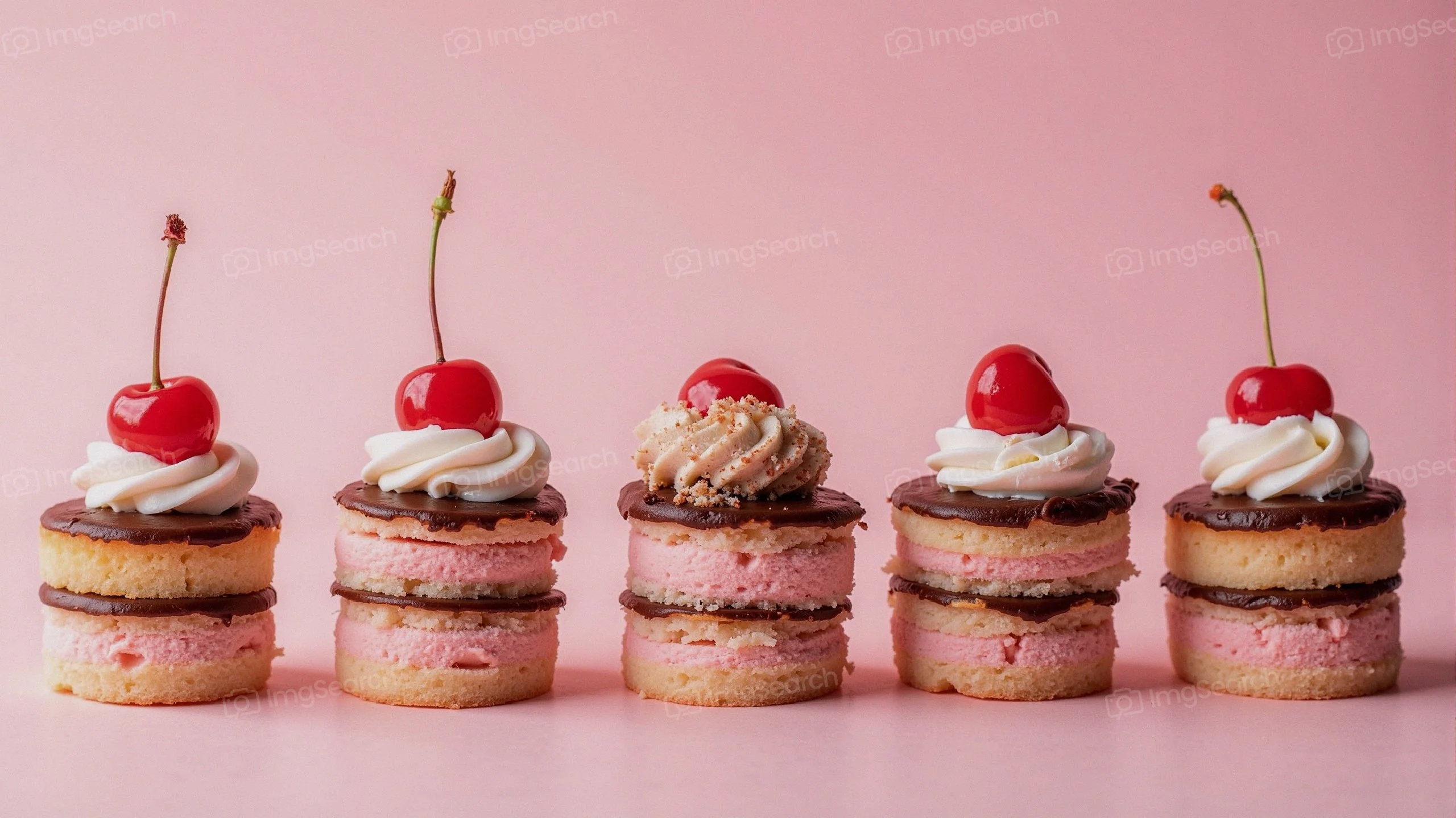 A row of colorful ice cream sandwiches topped with whipped cream cherries.