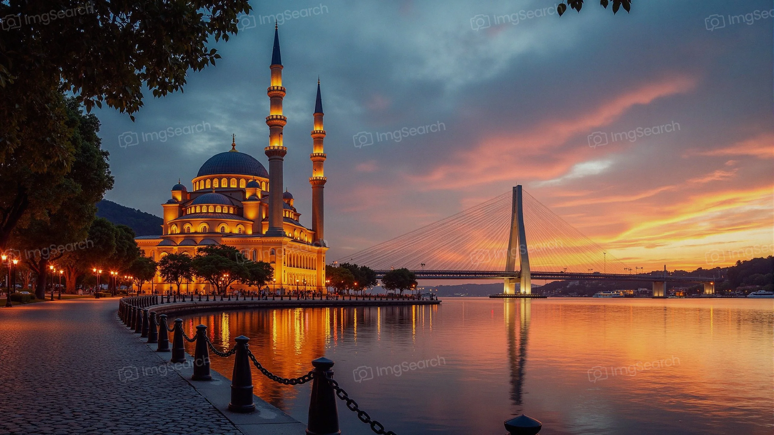A picturesque mosque illuminated by sunset light, with a bridge in the background reflecting on calm waters.