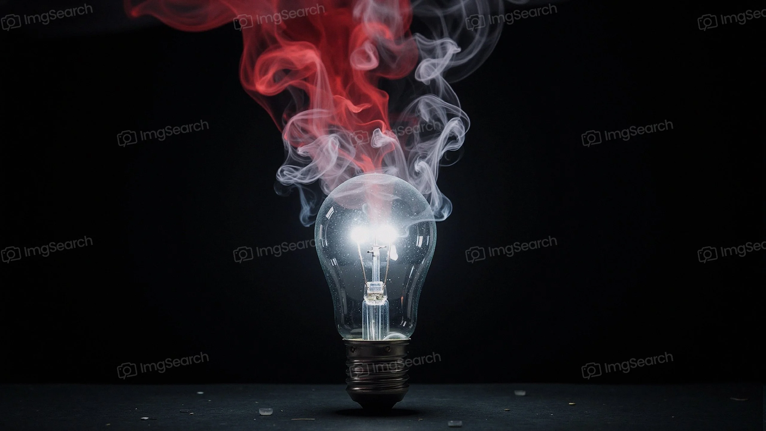 A glowing light bulb surrounded by red gray swirling smoke.
