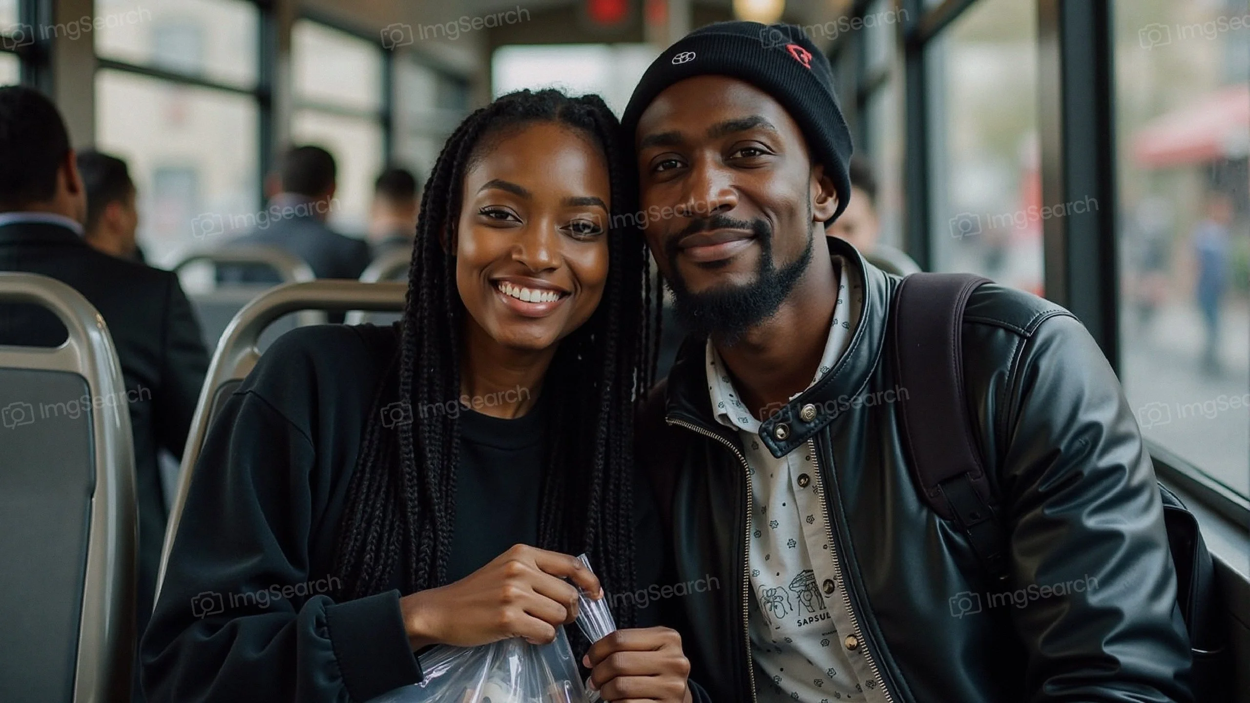 A smiling young couple sitting on a bus together, showcasing joy companionship.