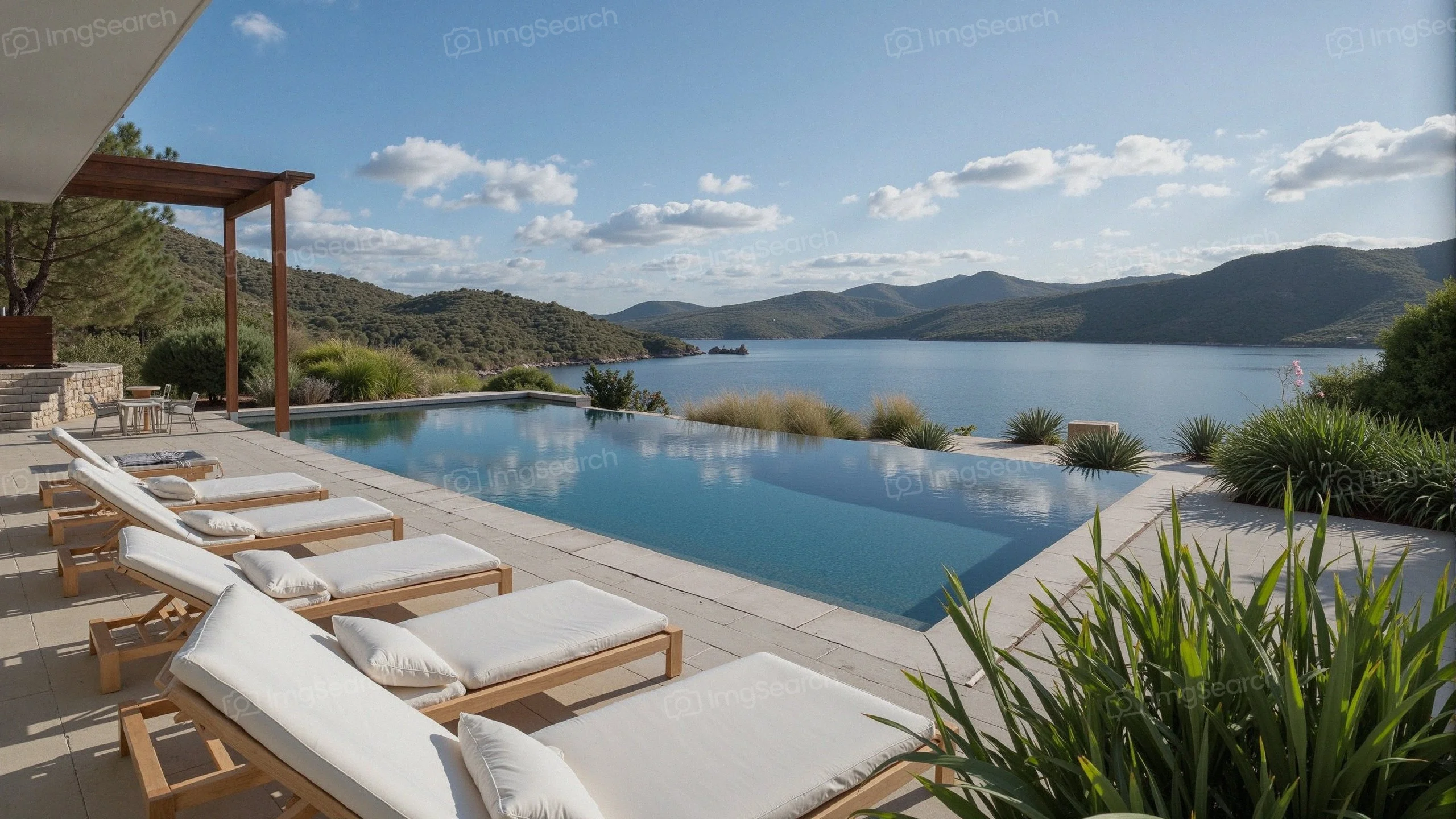 A beautiful lakeside retreat showcasing an infinity pool with lounge chairs scenic hills in the background
