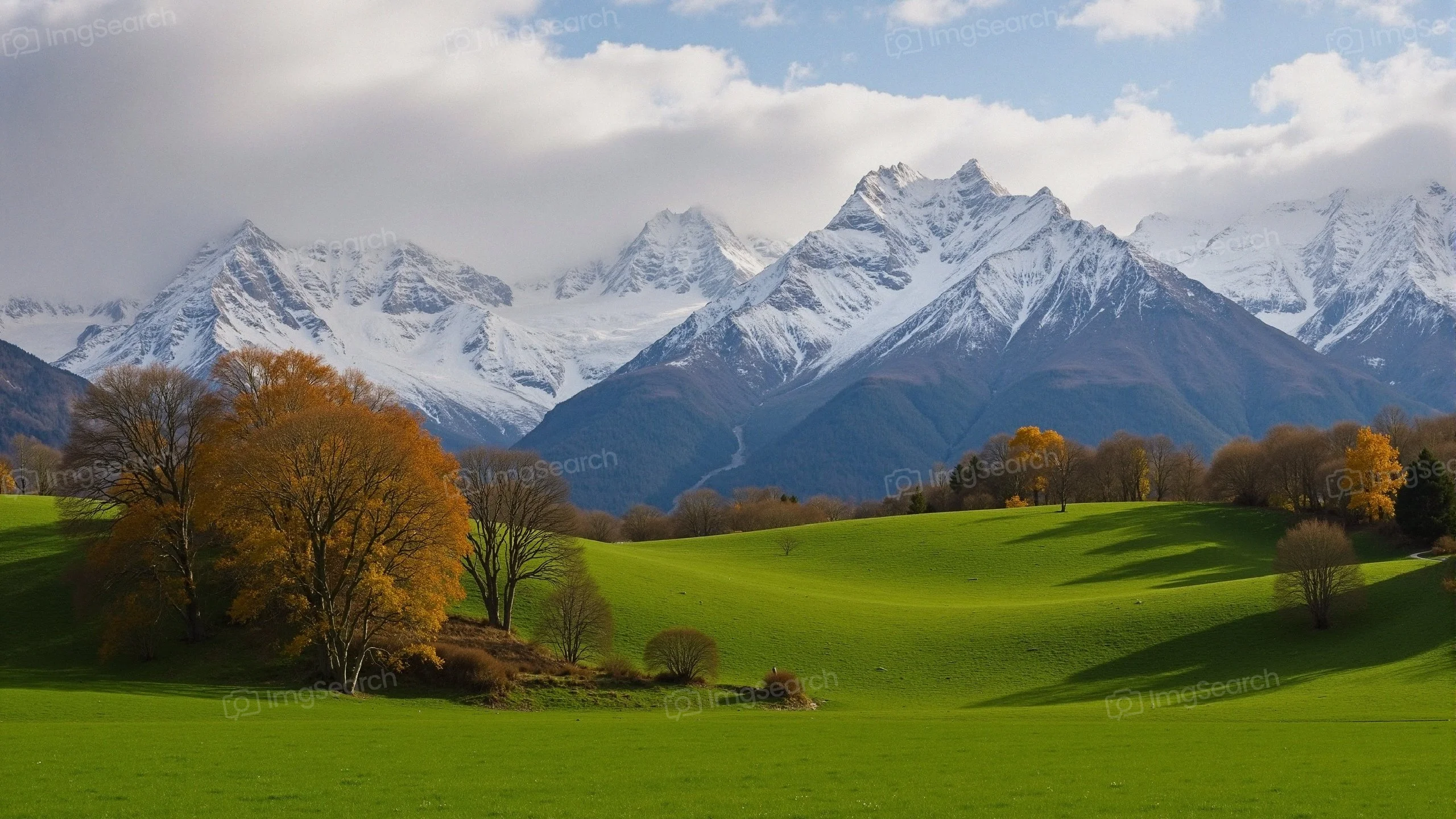 Scenic mountain landscape featuring snow-capped peaks autumn foliage