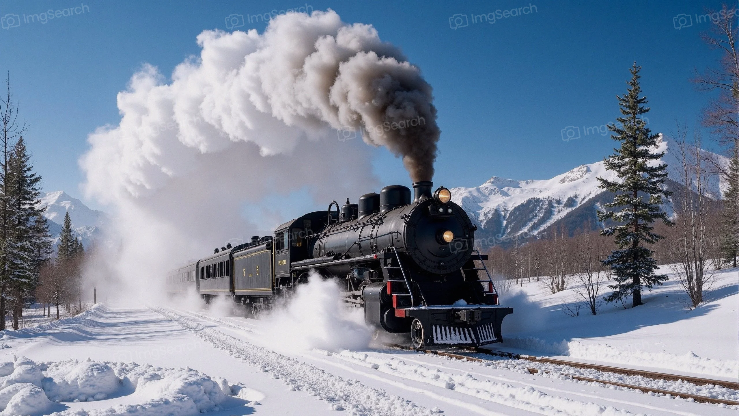 Vintage steam train traversing a snowy landscape with mountains in the background