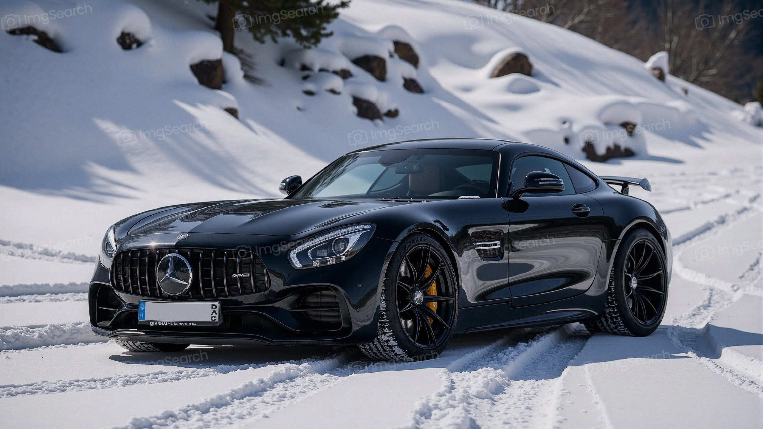 Black Mercedes-AMG GT parked on snow-covered terrain