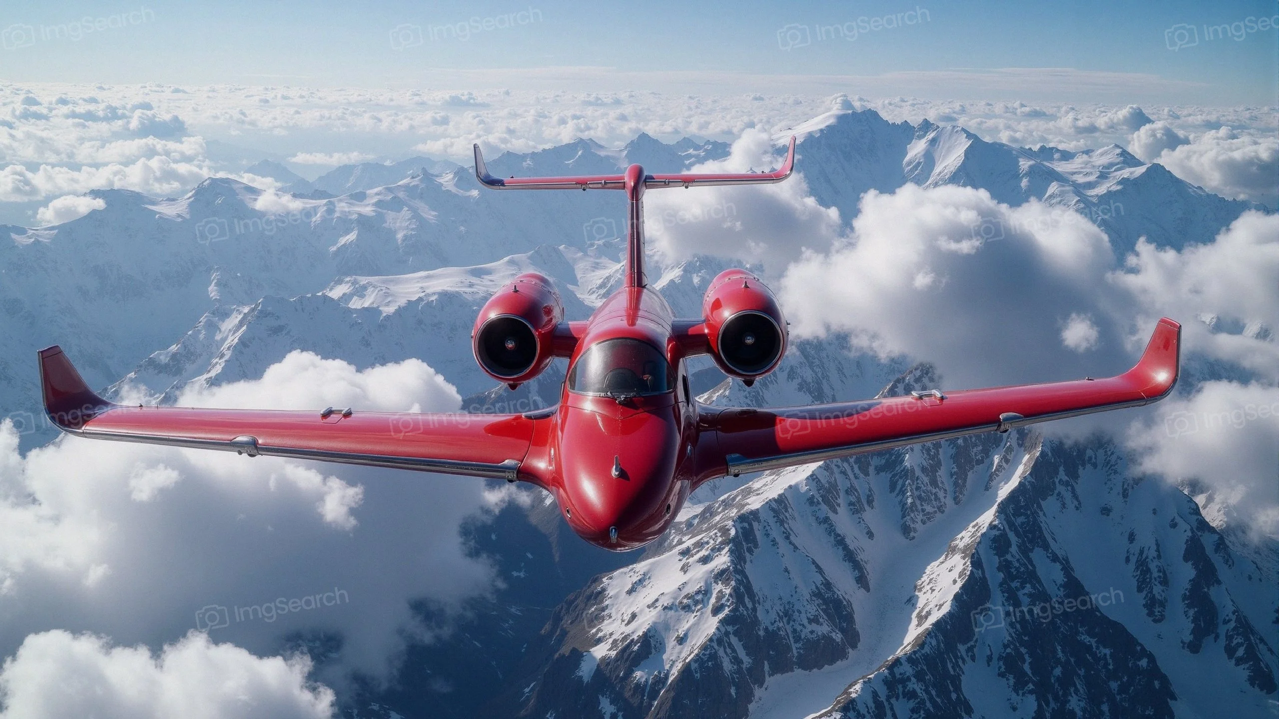 Red jet flying over snowy mountain peaks fluffy clouds