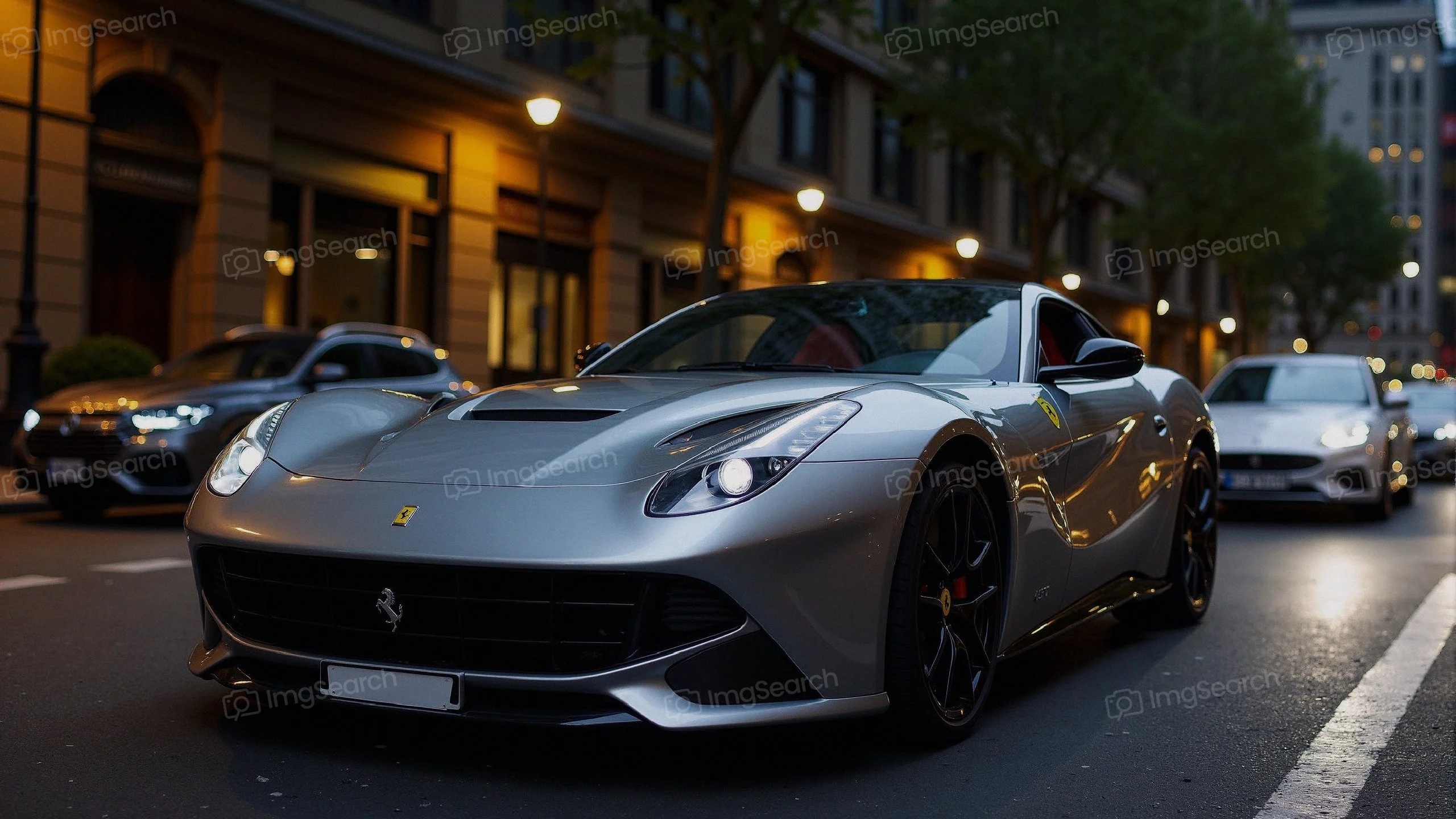 Silver Ferrari parked on a city street with urban backdrop