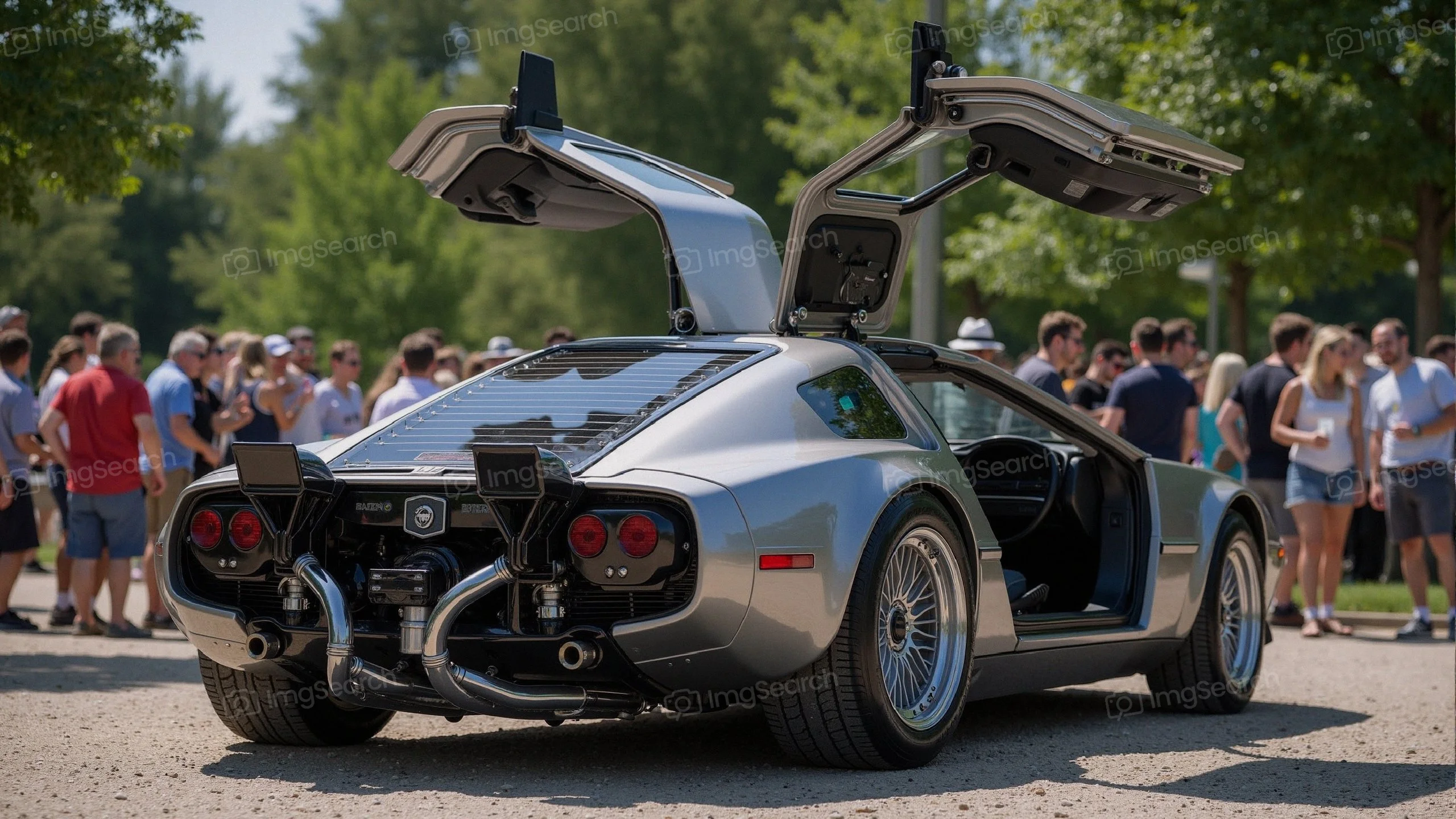 Silver sports car with gullwing doors in a crowd at a car show