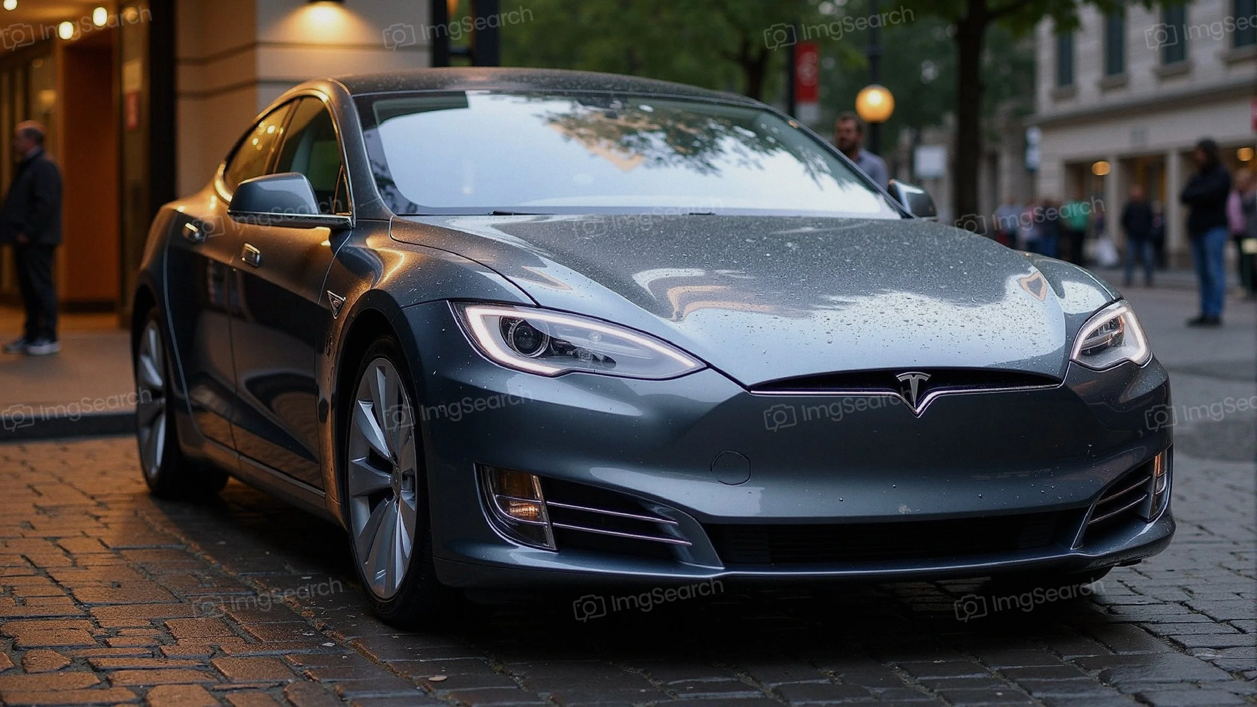 A Tesla Model S parked on a rainy cobblestone street, showcasing its sleek design modern features.