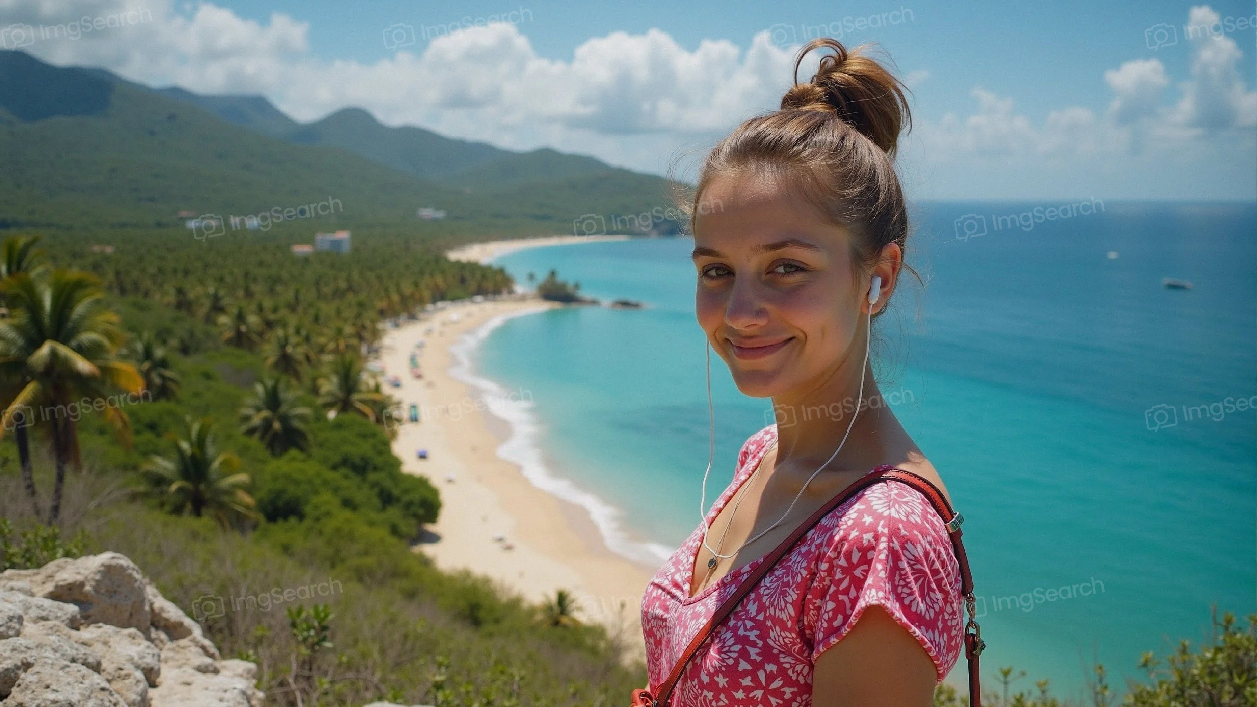 A young woman with a joyful smile standing on a tropical beach with palm trees blue ocean in the background.